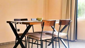 a table with two chairs and a laptop on it at Apartmani Tika in Golubac