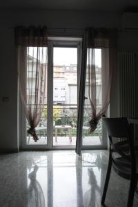 a room with a window with curtains and a table at Suite in Città residence in Isernia