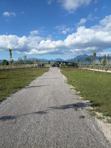 an empty road in a field with at LakeSide Camping in Koplik +9 photos
