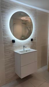 a bathroom with a white sink and a mirror at Max Wittelsheim in Wittelsheim +11 photos