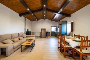 a living room with a couch and a table at Casa ATARAXIA in Boiro