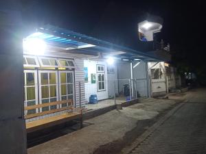 a house with a lit up roof at night at Wahid Homestay in Ketapang
