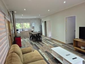 a living room with a couch and a table at Complejo Alto La Invernada in Las Trancas