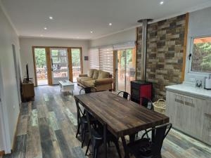 a living room with a wooden table and a couch at Complejo Alto La Invernada in Las Trancas