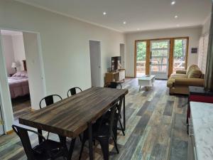 a living room with a wooden table and a couch at Complejo Alto La Invernada in Las Trancas +70 photos