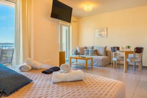 a living room with a bed and a couch at Vereniki Apartments in Finikounta