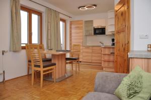 a living room with a table and a kitchen at Ferienhof Berger in Rossleithen