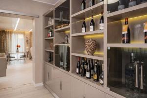 a wine cellar with a wall of wine bottles at Maison Villa Scherlin in Bardolino