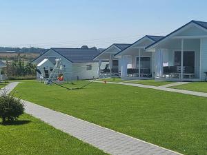a yard with some houses and a playground at Zante Sarbinowo in Sarbinowo