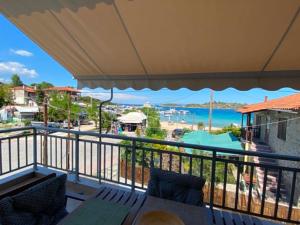 a balcony with a view of a beach and the ocean at Sophies Apartments Ormos in Ormos Panagias
