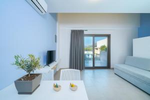 a living room with a couch and a table at Thassos OLIVIA RESORT in Potos
