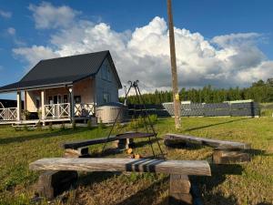a log cabin with a playground in a field at #Fuleda#Giżycko Fuledzianka domek na Mazurach #bania #jacuzziklimat in Giżycko