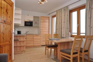 a kitchen and dining room with a table and chairs at Ferienhof Berger in Rossleithen