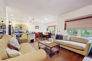 a living room with two couches and a table at Mountain Retreat in Basalt