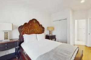 a bedroom with a large white bed with a wooden headboard at Mountain Retreat in Basalt
