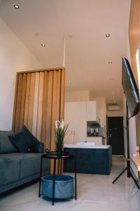 a living room with a couch and a table at fenias luxury studios in Kallithea Halkidikis