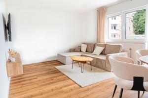 a living room with a couch and a table at Modern Stay in Lemgo