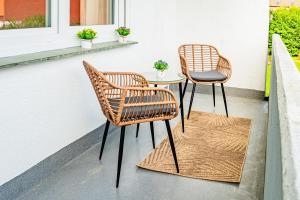 two chairs and a table on a patio at Modern Stay in Lemgo