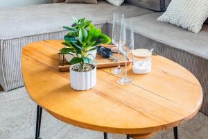 a wooden table with a plant and glasses on it at Modern Stay in Lemgo