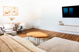 a living room with a couch and a table at Modern Stay in Lemgo
