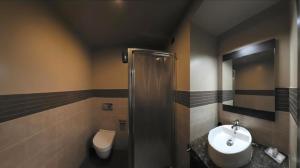 a bathroom with a sink and a toilet at Pisolo Resort in Sanremo