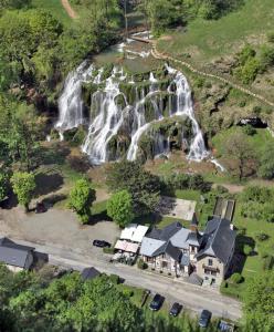 an aerial view of a waterfall next to a house at L'inattendu in Les Piards