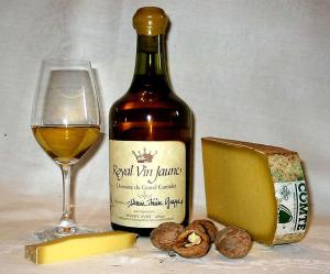 a bottle of wine next to a glass and cheese at L'inattendu in Les Piards