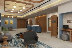 a lobby with a waiting area with chairs and tables at Courtyard by Marriott Torreón in Torreón +30 photos
