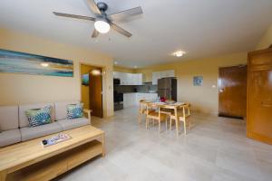 a living room with a couch and a table at Santa Cruz Suites in Lower South Hill
