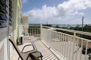 a balcony with a chair and a view of the ocean at Santa Cruz Suites in Lower South Hill