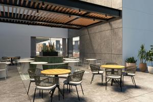 a patio with tables and chairs and a fountain at Courtyard by Marriott Torreón in Torreón