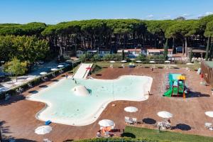 a large pool with a slide and a playground at Camping Pineta - Nikoli Tour in Cesenatico