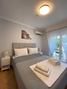 a bedroom with a bed with two towels on it at MarSia Apartment in Chios