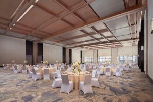 a banquet hall with white tables and white chairs at Beijing Marriott Hotel Yanqing in Yanqing +54 photos