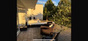 a patio with chairs and a couch on a house at Ferienoase am See in Möhnesee