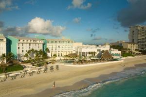 a view of a beach with a group of people at The Westin Cancun Resort & Spa in Cancún