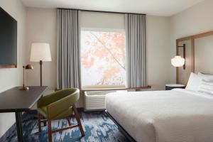 a hotel room with a bed and a desk and a window at Fairfield by Marriott Inn & Suites Kanab in Kanab