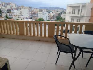 a balcony with a table and chairs and a view at Demy's apartment in Lavrio