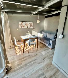 a living room with a table and chairs and a couch at Rent Montañeses Nuñez in Buenos Aires