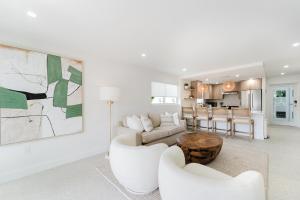 a living room with a couch and a table at The Mizner - 2BR Waterfront Boca Suite in Boca Raton