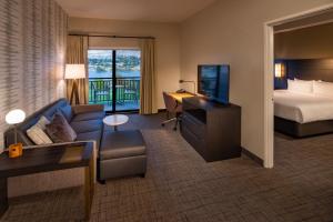 a hotel room with a bed and a couch and a desk at Residence Inn by Marriott Wenatchee in Wenatchee +33 photos
