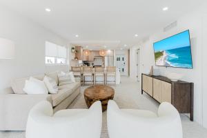 a living room with a couch and a table at The Mizner - 2BR Waterfront Boca Suite in Boca Raton