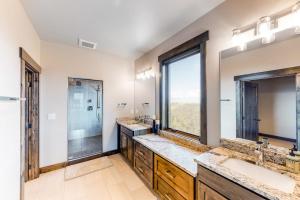 a bathroom with two sinks and a large window at Peaceful Bay Getaway in Lakeside +71 photos