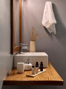 a bathroom counter with a sink and a mirror at Milesian Suites in Adamantas