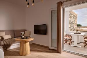 a living room with a couch and a table at Milesian Suites in Adamantas