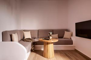 a living room with a couch and a table at Milesian Suites in Adamantas +71 photos