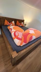 a bed with two comforters on top of it at Davenna Loft in Bartholomäberg
