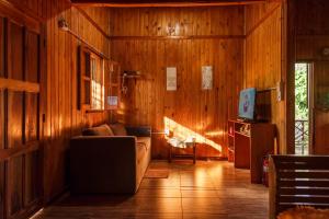 a living room with a couch and a television at Casa de la Guayubira in El Soberbio