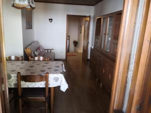 a dining room with a table and a chair at Appartamenti Kratter Valeria in Sappada +9 photos