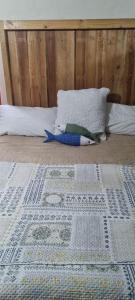 a bed with a comforter on it with a pillow and a bed with at Barnfires Farmhouse in Denysville